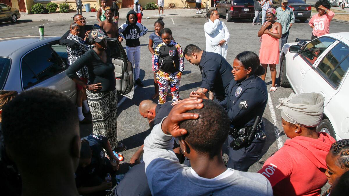 A handful of Los Angeles police officers worked furiously to keep an unconscious man alive Tuesday morning in Nickerson Gardens, hours after police shot and killed another man in the Watts housing project.