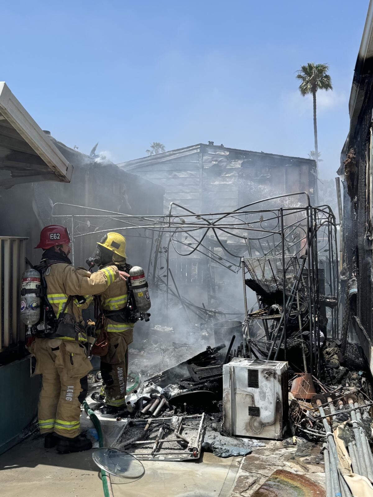 Firefighters check through the remains of one of the buildings damaged.