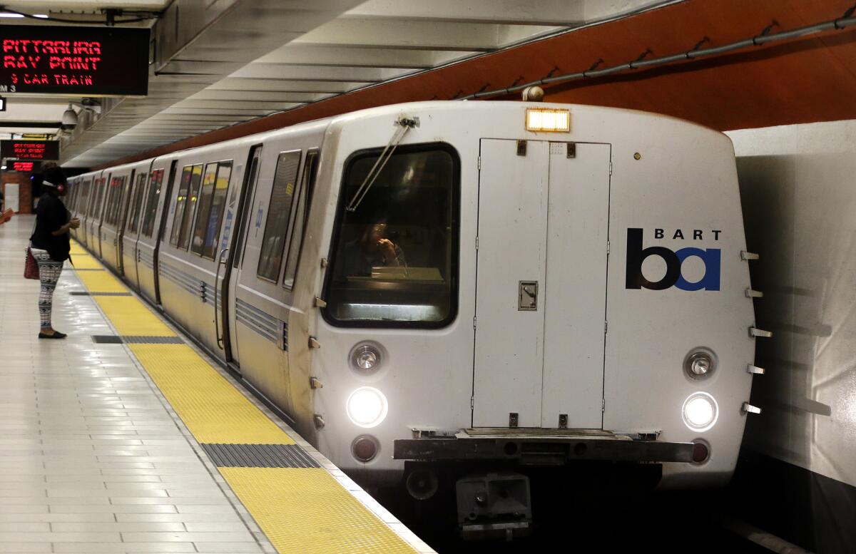 A Bay Area Rapid Transit train arrives at a station in Oakland.