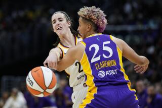 Indiana Fever guard Caitlin Clark (22) passes against Los Angeles Sparks guard Layshia Clarendon.