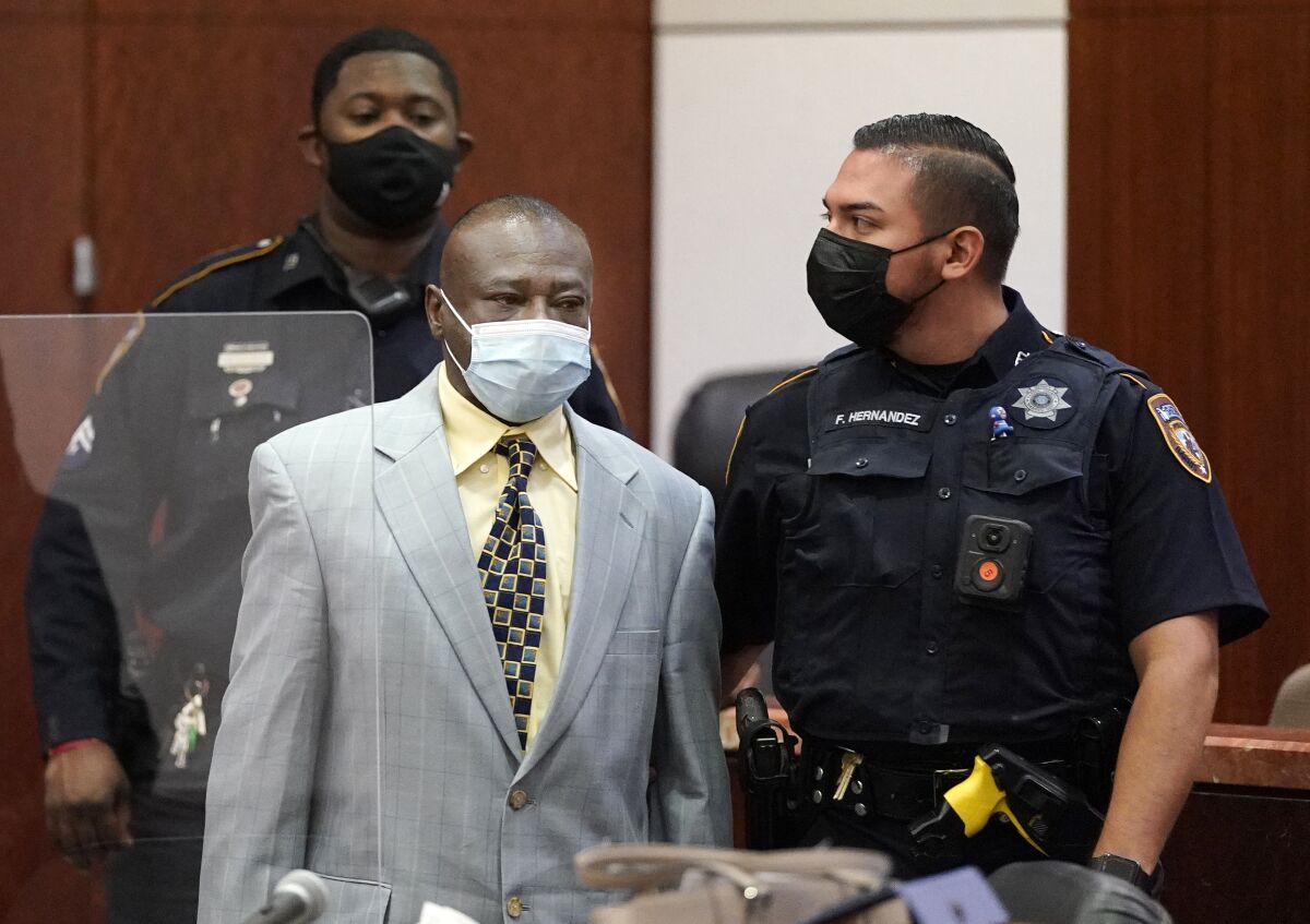 David Conley is escorted into the Harris County Criminal Court of Judge Chuck Silverman during his trial Tuesday, Oct. 5, 2021 in Houston, for the murders of eight people. Prosecutors are not seeking the death penalty, saying he has a mental disability. (Melissa Phillip/Houston Chronicle via AP)