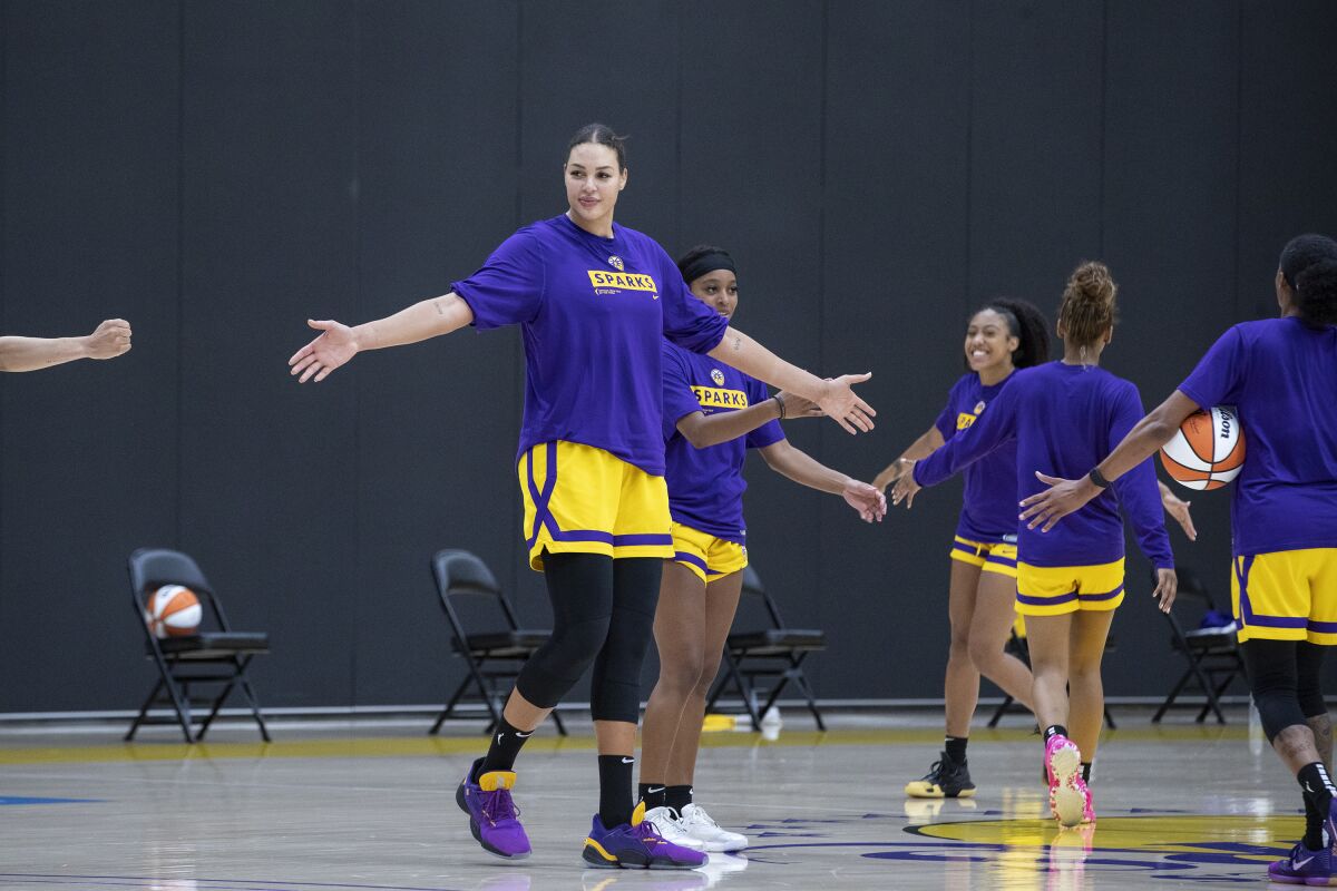 New Sparks center Liz Cambage greets her new teammates with hand slaps during a practice.