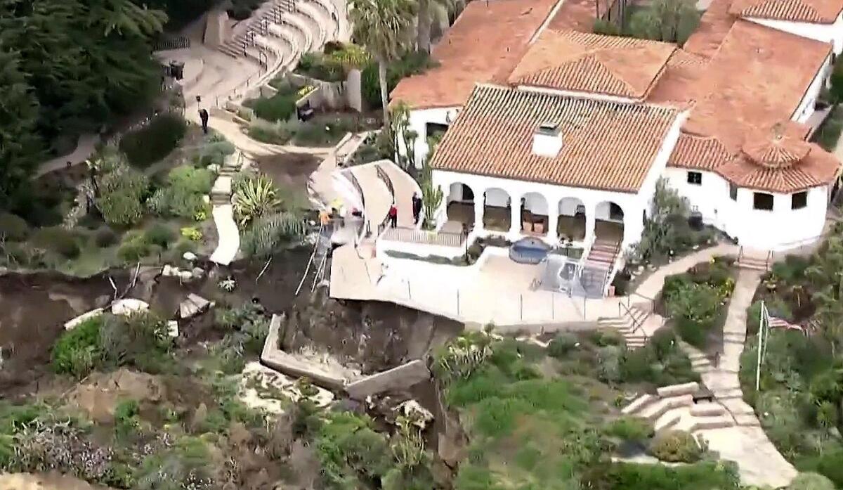 Aerial view of a collapsed hillside below a historic Spanish colonial revival building