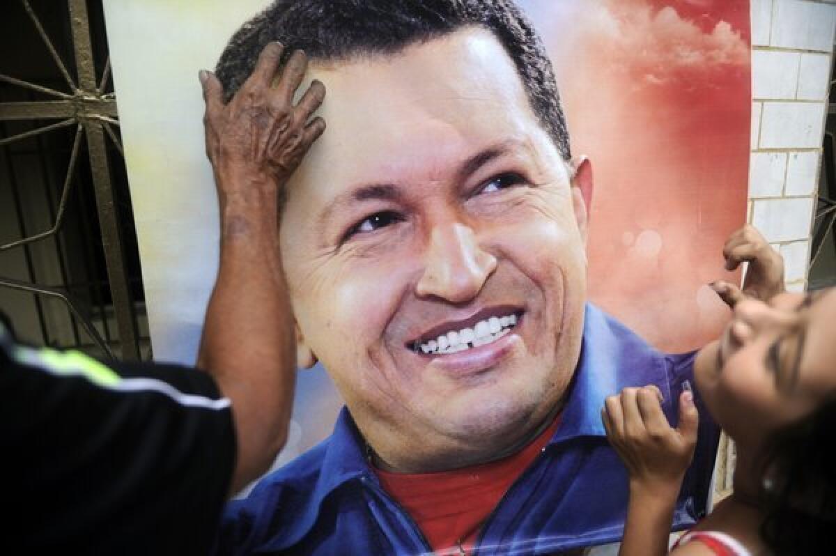 A poster of Hugo Chavez is hung as Venezuela mourns its former president. Even after Chavez's death, experts predict that gasoline will still be heavily subsidized by the government.
