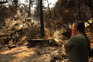 David Mix stands in front of his cabin that was destroyed in the Bridge fire along Bear Canyon Road in Mount Baldy.