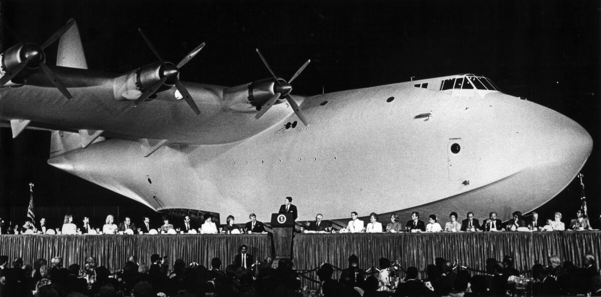 June 30, 1983: With the giant Spruce Goose providing a background, President Reagan addresses a Republican fund-raising dinner.