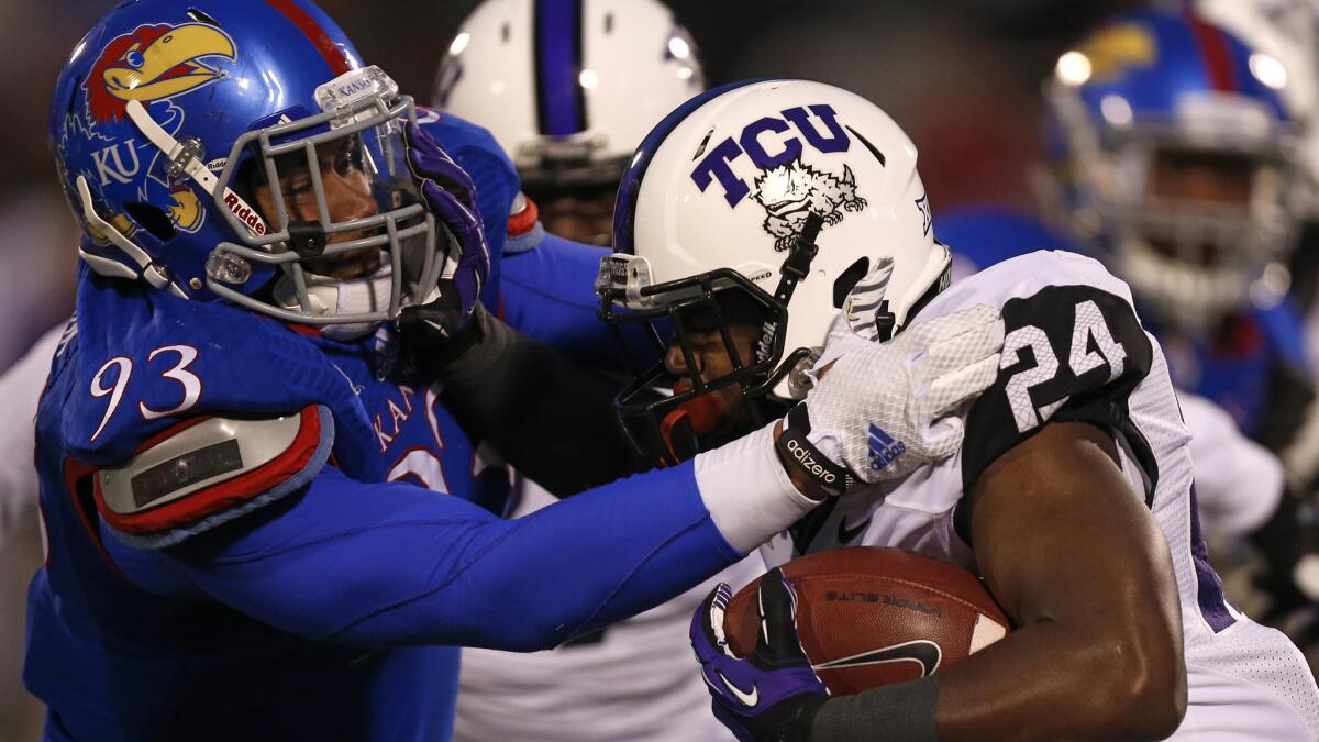 Kansas defensive lineman Ben Goodman, left, tries to bring down TCU tailback Trevorris Johnson during the fourth quarter of the Horned Frogs' 34-30 win Saturday.