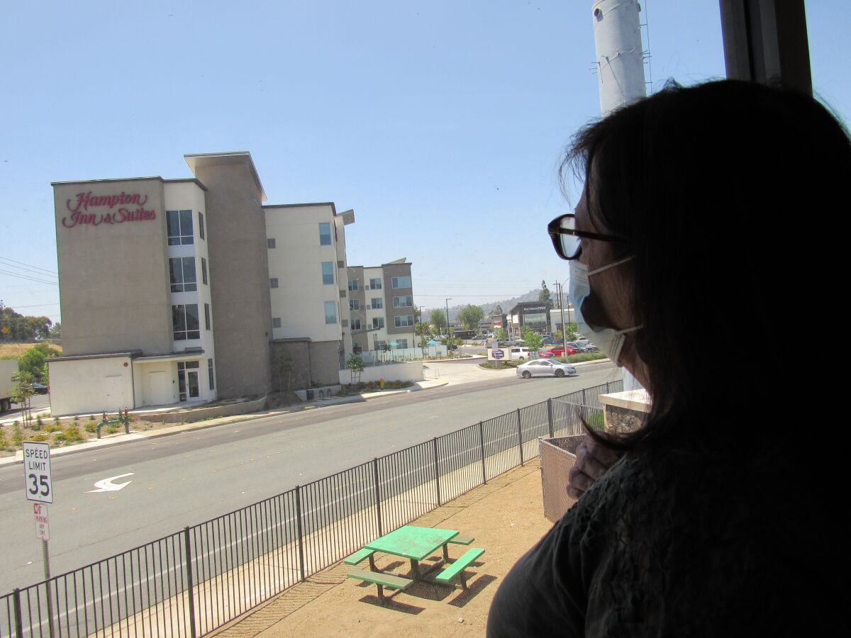 Crisis House Executive Director Mary Case looks out her office window at the Hampton Inn & Suites across the street.
