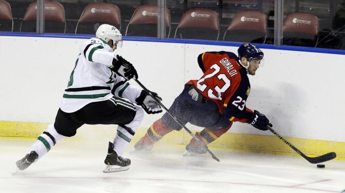 Panthers forward Rocco Grimaldi, right, drives as Dallas defenseman Alex Goligoski defends during a game on Sept. 24.
