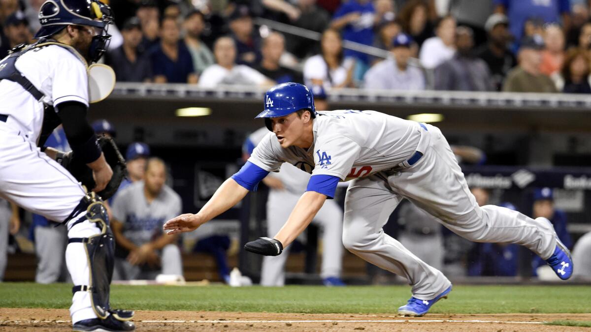 Corey Seager, making his debut for the Dodgers, scores against catcher Derek Norris and the Padres in the sixth inning of a Sept. 3 game in San Diego.
