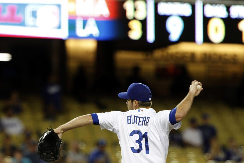 Dodgers catcher Drew Butera pitches against the Marlins in the ninth inning Wednesday night at Dodger Stadium.