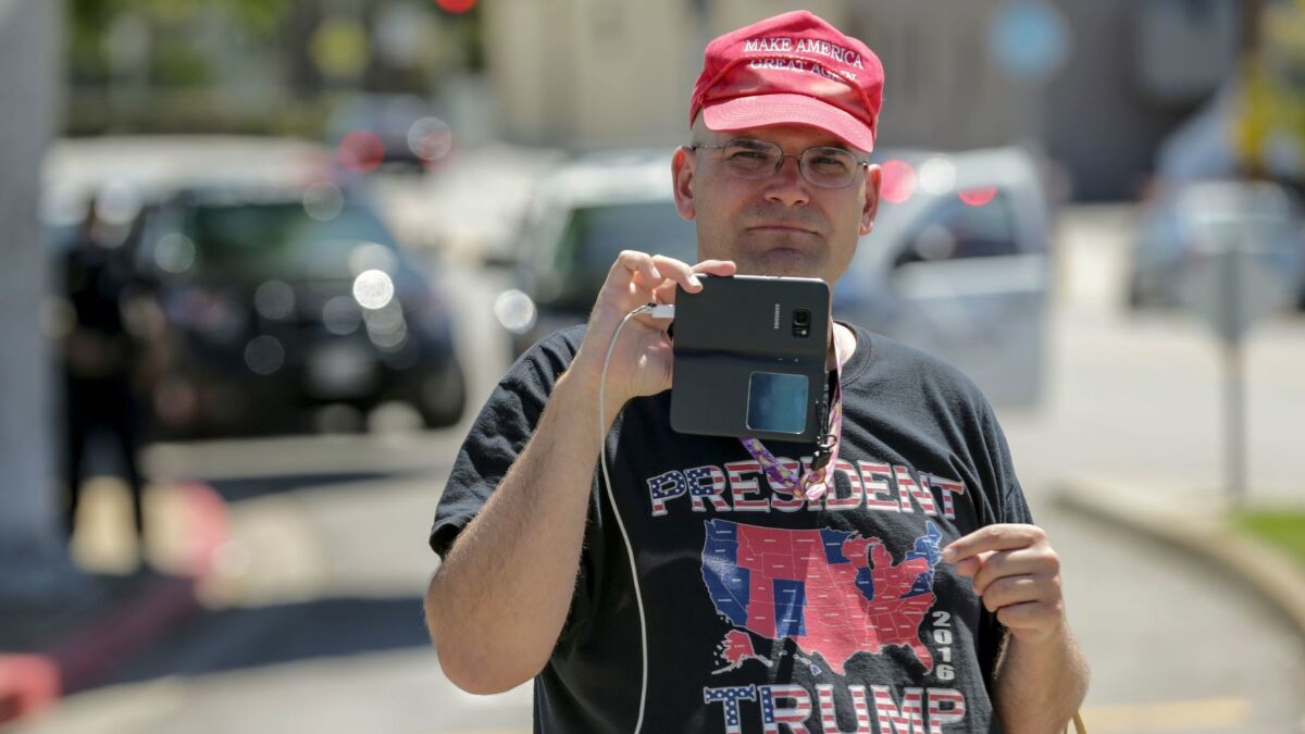 Arthur Christopher Schaper streams live video of a confrontation he was involved with outside a town hall meeting hosted by U.S. Rep. Maxine Waters (D-Los Angeles) in Inglewood on May 13. (Irfan Khan / Los Angeles Times)