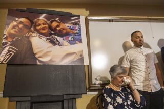 CORONA, CA-AUGUST 26, 2019: Paola French and her son Kevin react as Attorney Dale Galipo addresses the media during a press conference at the Ayres Hotel in Corona to announce plans to file a civil claim against the city of Los Angeles and LAPD officer Salvador Sanchez for the shooting death of PaolaÕs son, Kenneth French inside a Corona Costco earlier this year. Photograph at left is of from left to right-Kenneth French and his parents, Paola, and Russell, taken in 2019. (Mel Melcon/Los Angeles Times)
