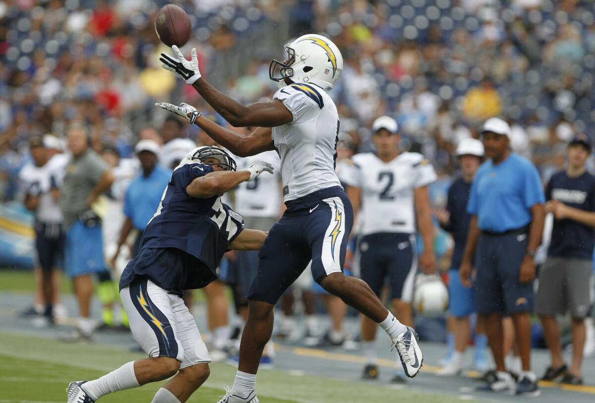 The Chargers' Javontee Herndon makes a catch over Greg Ducre in practice.