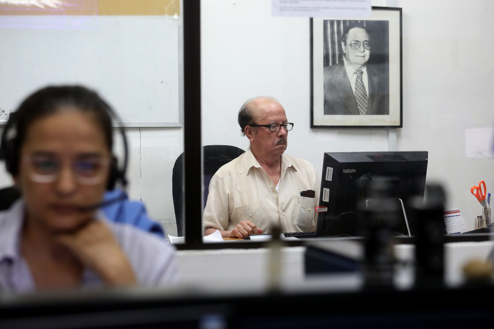 Editorial page editor Luis Sánchez Sancho at work. Behind him is a portrait of Pedro Joaquín Chamorro, the longtime publisher of La Prensa who was killed in 1978.