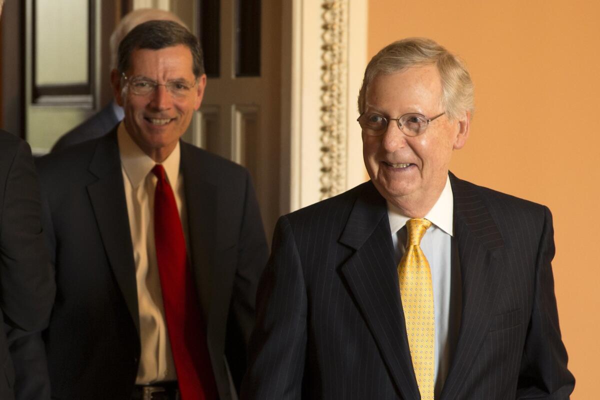 Senate Majority Leader Mitch McConnell of Ky., right, followed by Sen. John Barrasso, R-Wyo., leaves a GOP luncheon on Capitol Hill in Washington, Tuesday, May 5, 2015. (AP Photo/Brett Carlsen) The Associated Press