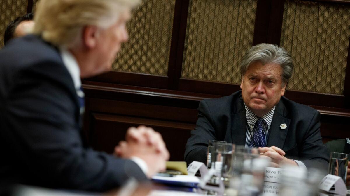 Then-White House Chief Strategist Steve Bannon listens as President Donald Trump speaks during a meeting in Washington on Jan. 31, 2017.
