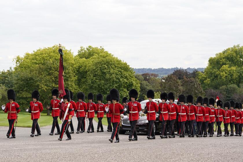 Soldiers escort the State Hearse as it arrives at Windsor Castle carrying the coffin of Queen Elizabeth II