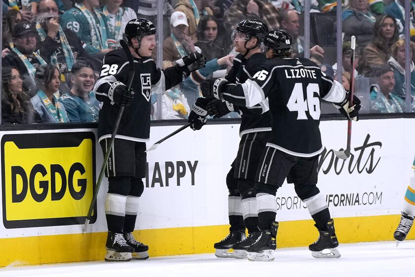 The Kings' Jaret Anderson-Dolan, left, is congratulated by Blake Lizotte and Carl Grundstrom after scoring Nov. 25, 2022.