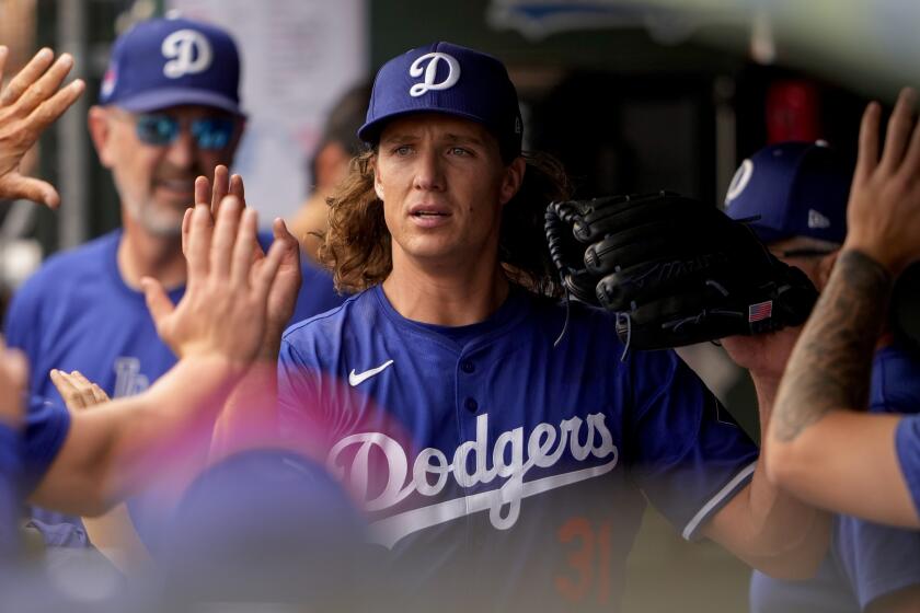 Los Angeles Dodgers starting pitcher Tyler Glasnow is greeted by teammates after being relieved.