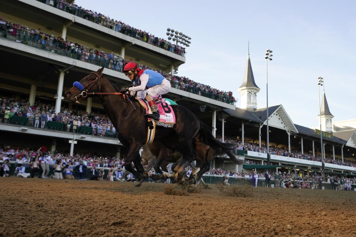 Jockey John Velazquez rides Medina Spirit across the finish line to win the 147th running of the Kentucky Derby.