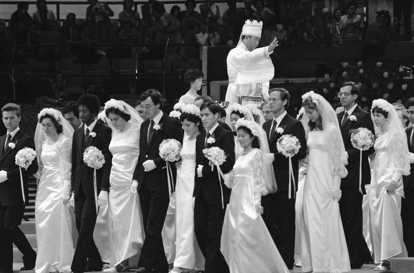 Couples march in a mass wedding procession in New York's Madison Square Garden as the Rev. Sun Myung Moon presides over the ceremony, which included more than 2,000 couples. Moon served as matchmaker for the couples. About a third included men and women of difference races or nationalities, in keeping with the church's belief that interracial marriage can help end racism.