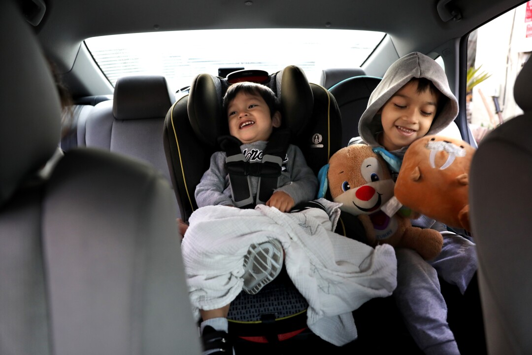 Daniel and Alfredo in the family's sedan before heading to school.