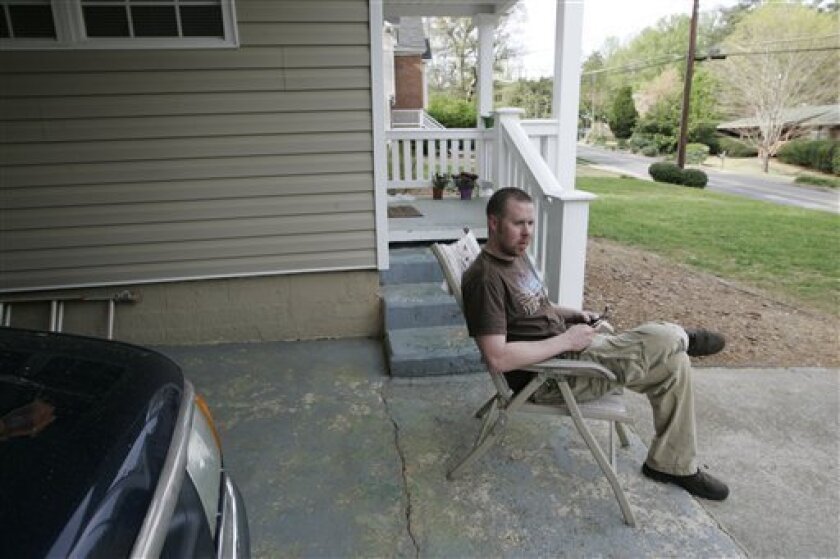Jason Rhoads, a Lockheed Martin crane operator, sits in his driveway Thursday, April 9, 2009, in Marietta, Ga. Jason Rhoads, a Lockheed Martin crane operator, sits in his driveway Thursday, April 9, 2009, in Marietta, Ga. Rhoads wonders if he might be headed for the ranks of the unemployed, as the Defense Department seeks to scrap or scale back some of its most expensive weapons programs, including the F-22 stealth fighter, which is assembled at Lockheed's Marietta plant. (AP Photo/John Amis)
