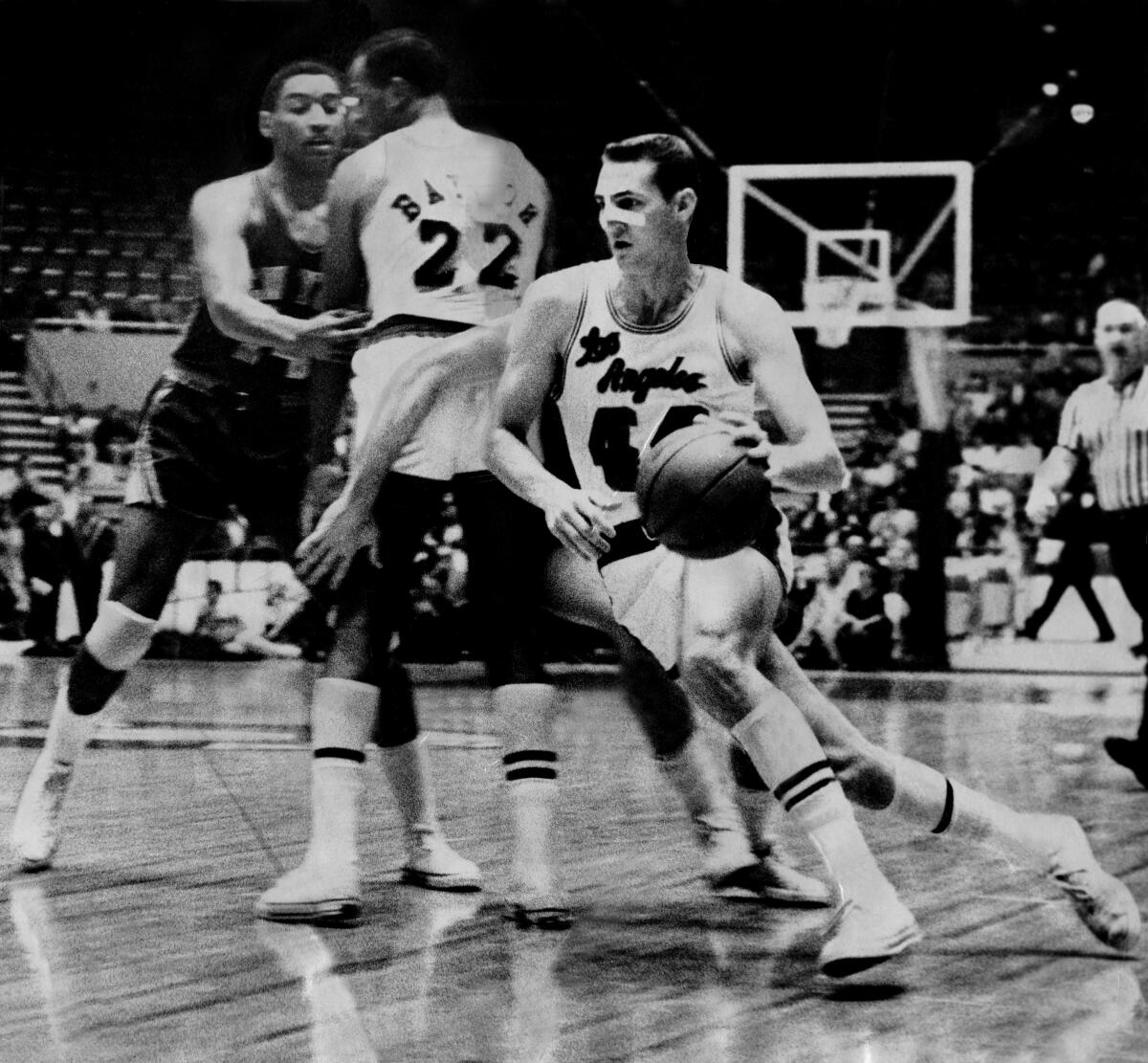 Jerry West, protected by Elgin Baylor, drives to the basket during a Laker game at the L.A. Memorial Sports Arena in 1965. 
