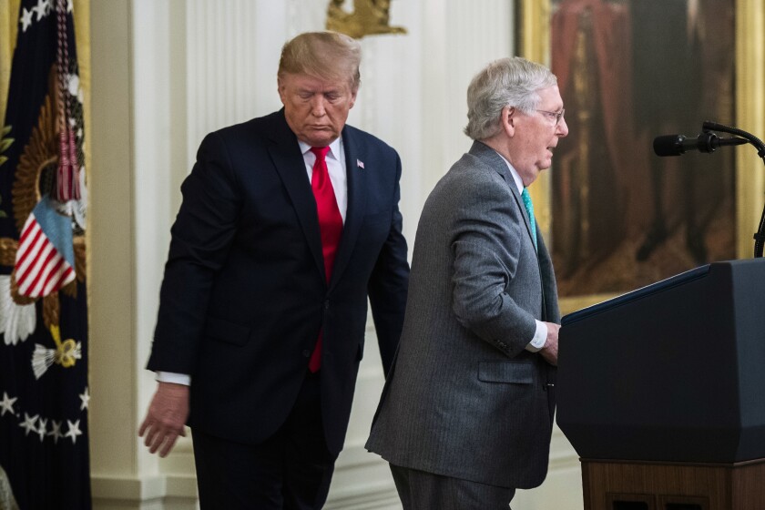 Then-President Trump and then-Senate Majority Leader Mitch McConnell near a lectern