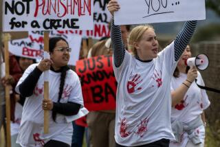 CHINO, CA. APRIL 14, 2024: More than two-dozen protesters marched with signs and shouted with bullhorns in front of the California Institution For Women in Chino April 14, 2024. The group was comprised of USC students, members of the California Coalition For Women Prisoners (CCWP) and the Women's Liberation Front, protesting recent sexual abuse allegations against a few of the wardens and guards in the system. (Mark Boster / For The Times)