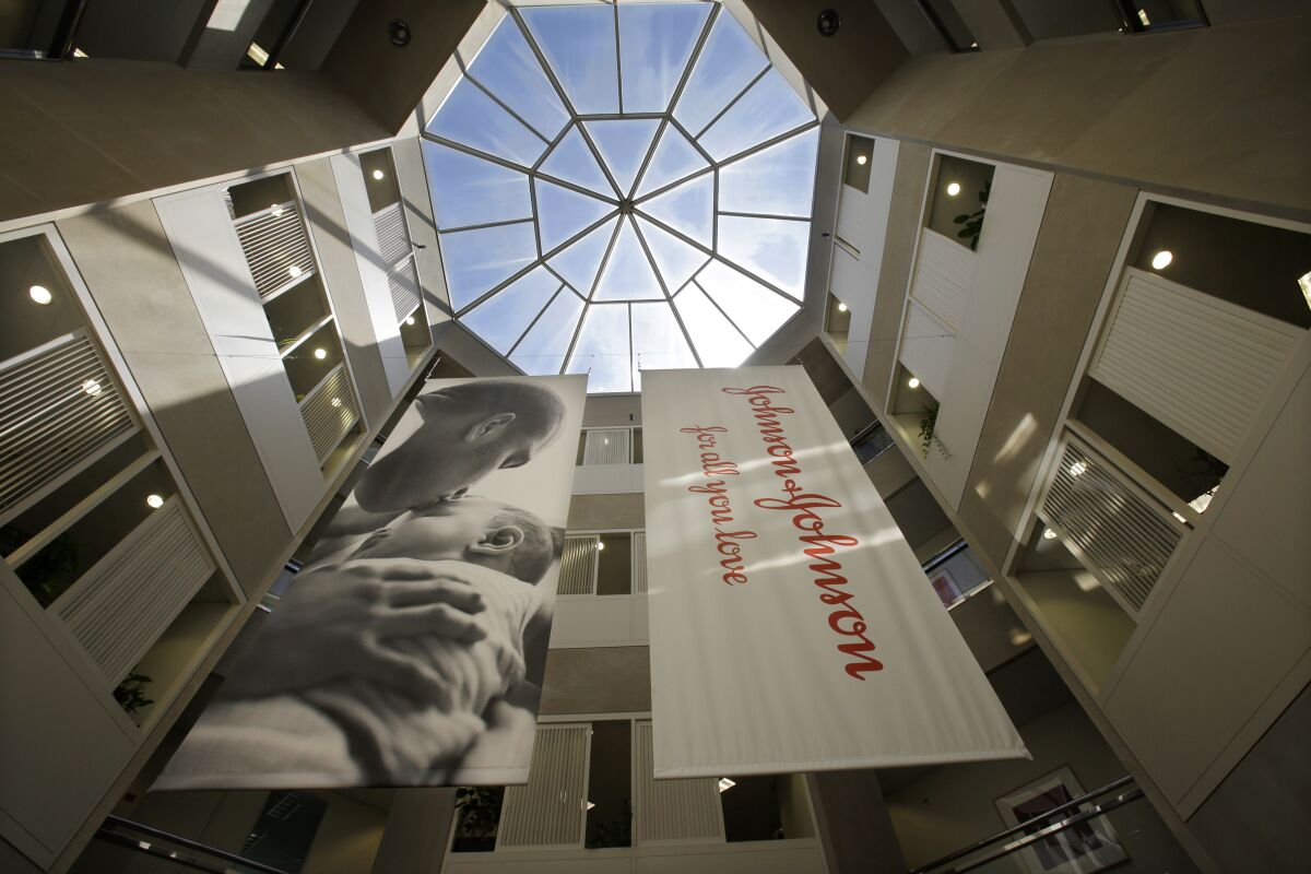 FILE - In this July 30, 2013, photo, large banners hang in an atrium at the headquarters of Johnson & Johnson in New Brunswick, N.J. A California appeals court on Monday, April 11, 2022, has ruled Johnson & Johnson must pay $302 million in penalties to the state for deceptively marketing pelvic mesh implants for women. (AP Photo/Mel Evans, File)