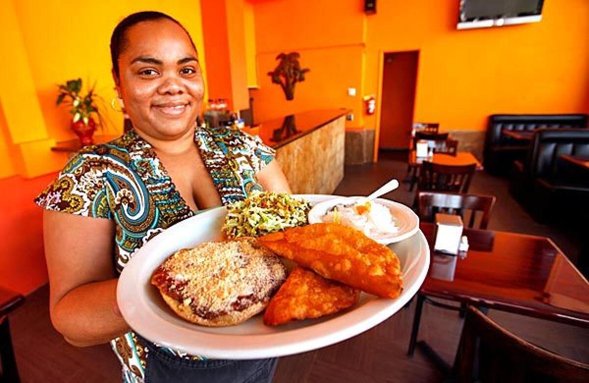 Tifara Smith shows a sampler platter at Flavors of Belize.