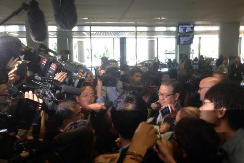 Asiana Airlines President Yoon Young-doo is swarmed by reporters upon his arrival at San Francisco International Airport.