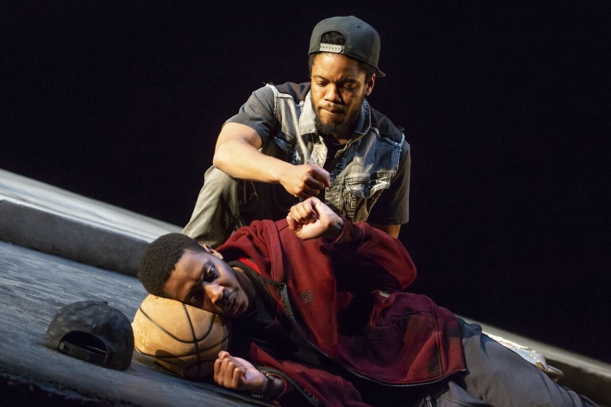 This image released by Lincoln Center Theater shows Namir Smallwood, foreground, and Jon Michael Hill in a scene from "Pass Over" in New York. Previews start Aug. 4, with an opening set for Sept. 4. (Jeremy Daniel/Lincoln Center Theater via AP)