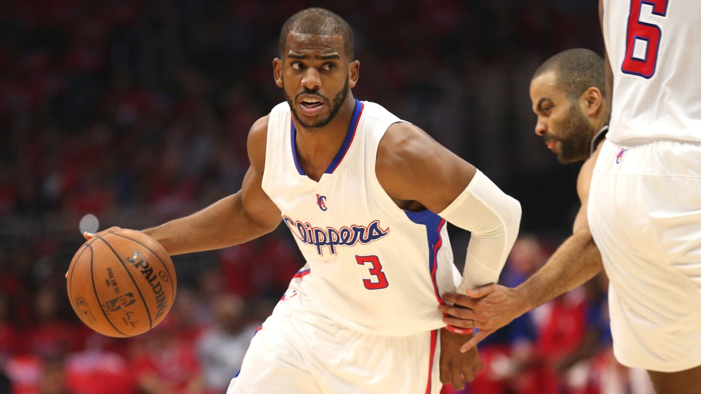 Clippers point guard Chris Paul dribbles around San Antonio Spurs guard Tony Parker during the first half of Game 7 of the Western Conference quarterfinals at Staples Center on May 2, 2015.