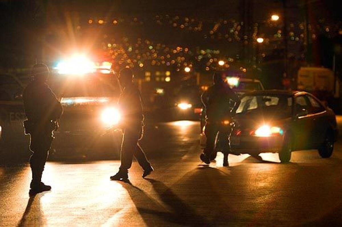 State police officers investigate the scene of a shoot-out between drug gangs in Tijuana, Mexico, Saturday, Oct. 4.