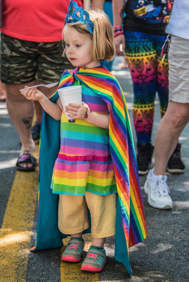 Dory Papier, 3, of Westminster marches down Main St. wearing lots of rainbows.
