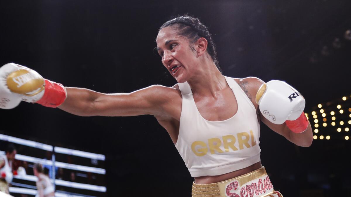 Amanda Serrano delivers a punch during a WBO world female featherweight championship match 