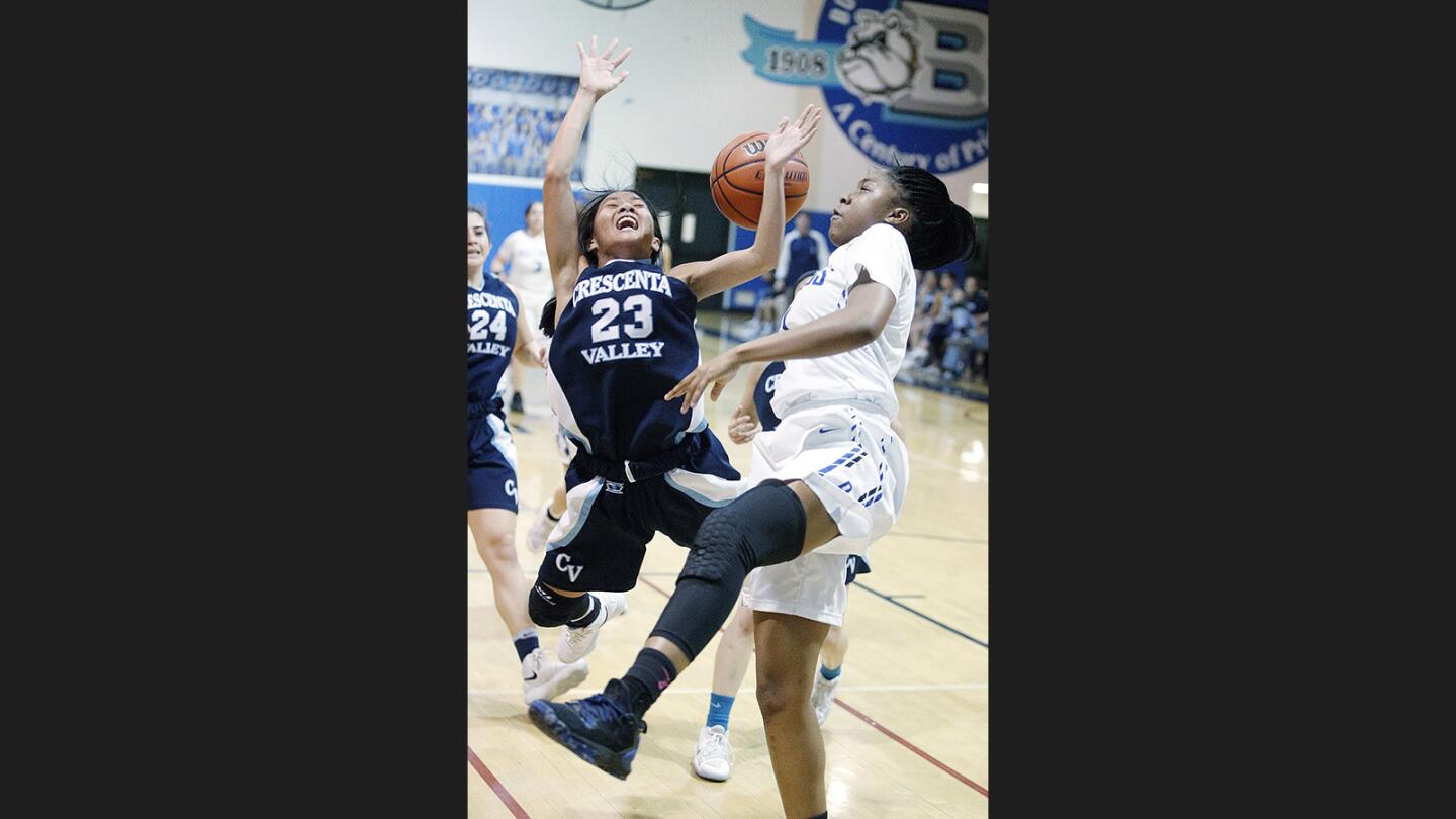 Crescenta Valley's Denise Dayag is blocked on a fast-break by Burbank's Jayla Flowers in a Pacific League girls' basketball game at Burbank High School on Tuesday, January 16, 2018.