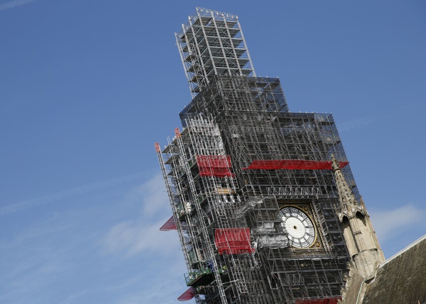 FILE - In this Tuesday, April 17, 2018 file photo, scaffolding surrounds the Queen Elizabeth Tower, which holds the bell known as Big Ben, in London. The bell of Britain’s Parliament has been largely silent since 2017 while its iconic clock tower undergoes four years of repairs. Brexit-backing lawmakers are campaigning for it to strike at the moment Britain leaves the European Union -- 11 p.m. (2300GMT) on Jan. 31. Parliamentary officials say it is not worth the cost, which could come to 500,000 pounds ($650,000). The House of Commons Commission said Tuesday, Jan. 14, 2020 that because the clock mechanism has been dismantled and the belfry is currently getting a new floor, arranging for the bell to ring “could result in huge costs to the public purse.” (AP Photo/Alastair Grant, file)