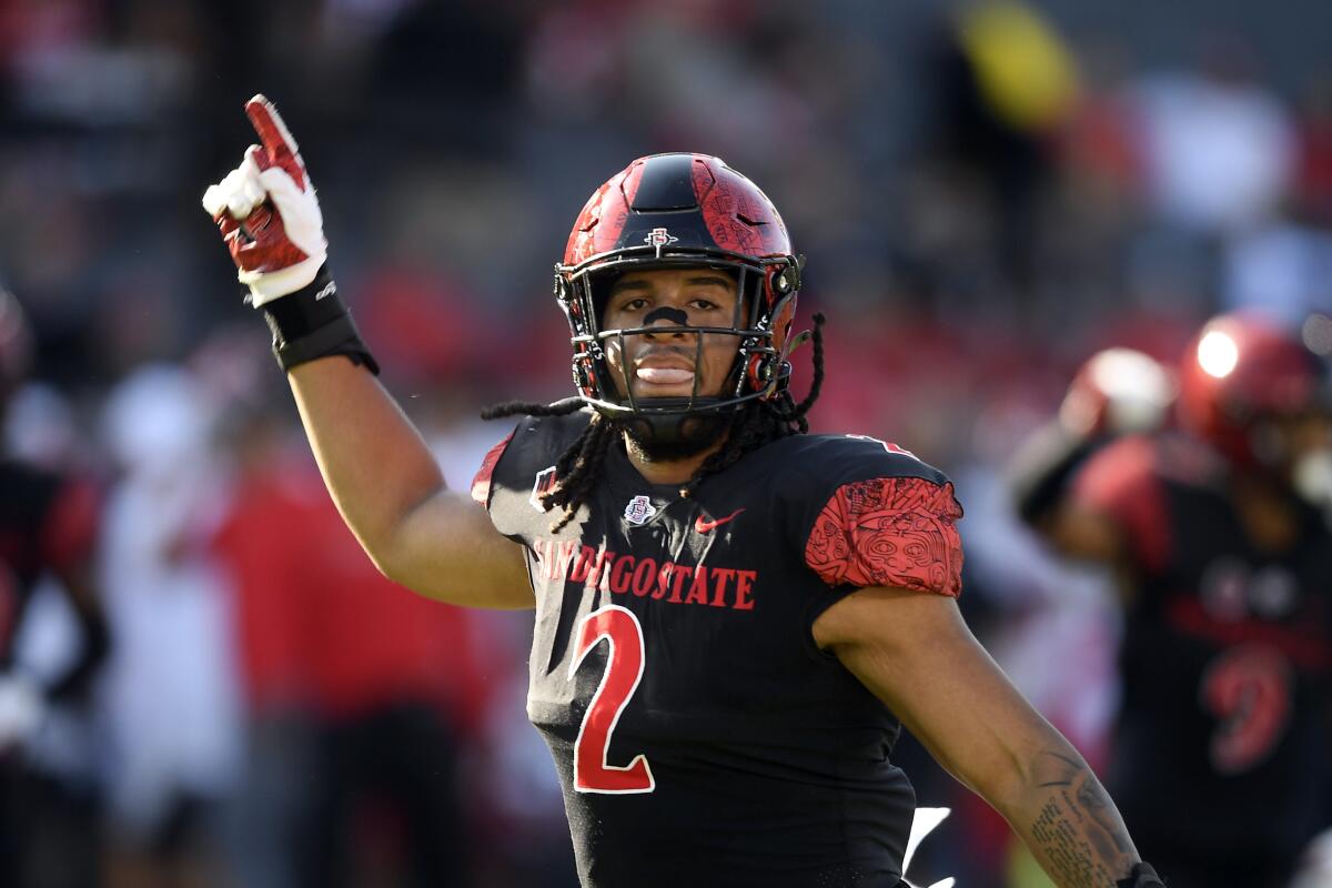 FILE - San Diego State defensive lineman Keshawn Banks (2) celebrates during an NCAA football game against Utah, Sept. 18, 2021, in Carson, Calif. SDSU is coming off a school-record 12-2 season and No. 25 finish in The AP Top 25. (AP Photo/Denis Poroy, File)