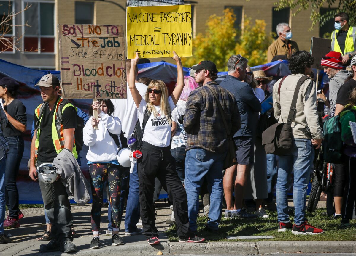 Protesters gather at the Foothills Hospital to oppose COVID-19 related public health measures in Calgary, Alberta, Canada, on Monday, Sept. 13, 2021. (Jeff McIntosh/The Canadian Press via AP)