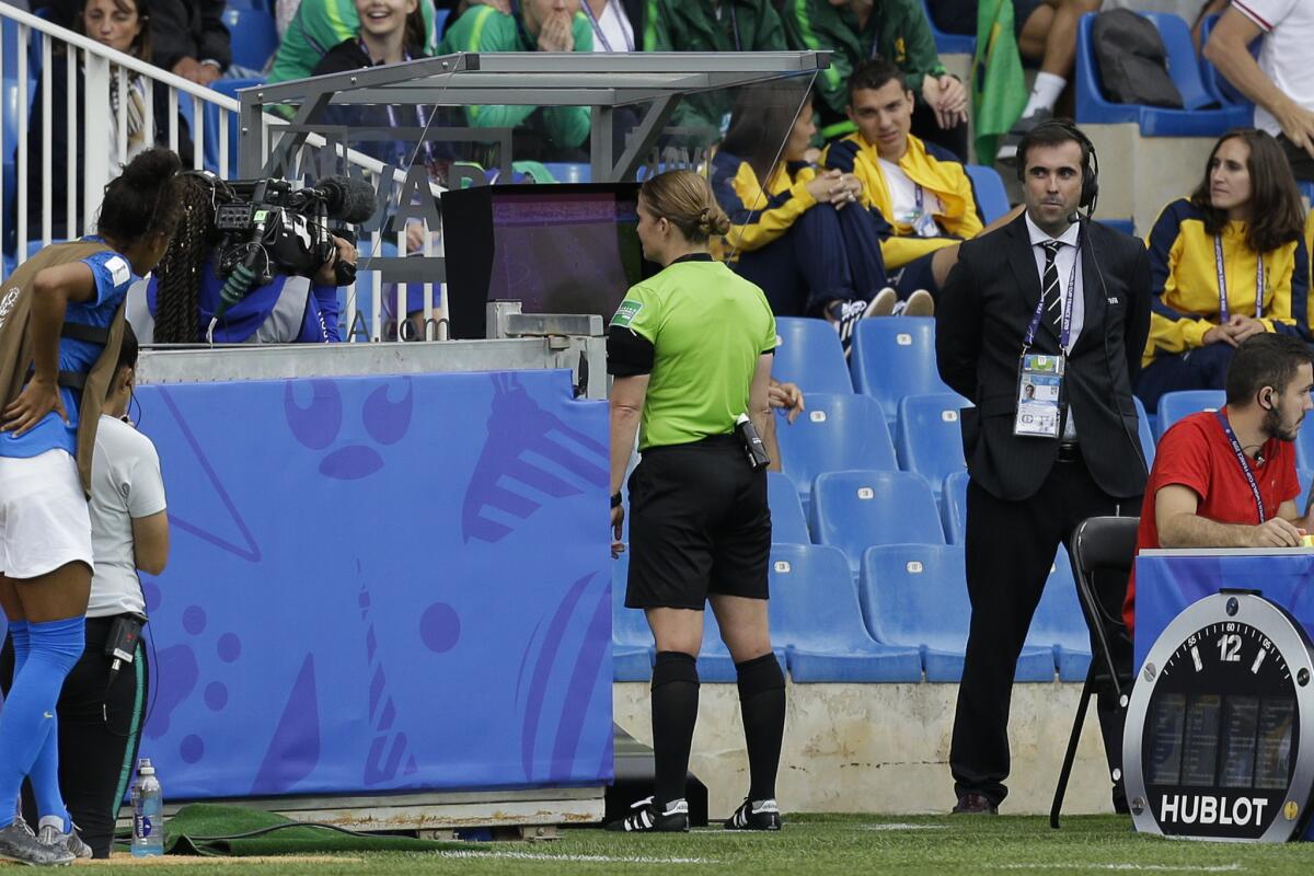 Esther Staubli from Switzerland watches the VAR monitor during the Women's World Cup Group C soccer match between Australia and Brazil at Stade de la Mosson in Montpellier, France, Thursday, June 13, 2019.