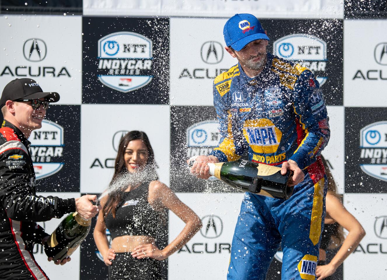 Long Beach Grand Prix winner Alexander Rossi, right, is sprayed with champagne by runner-up Josef Newgarden.