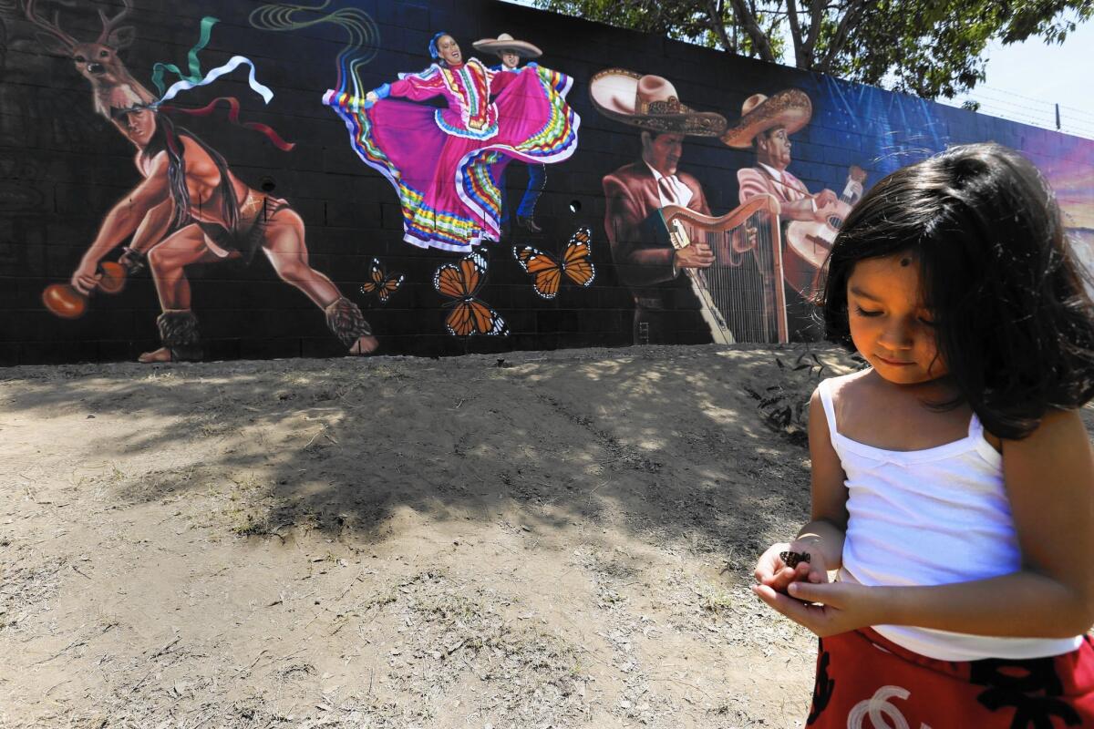 Long Beach dedicated Jenni Rivera Memorial Park on Thursday to honor the Mexican American singer who died in a plane crash in 2012. Rivera's granddaughter Jaylah Hope Yanez plays with a butterfly near the park's mural, dubbed the “Mariposa de barrio,” the neighborhood butterfly.