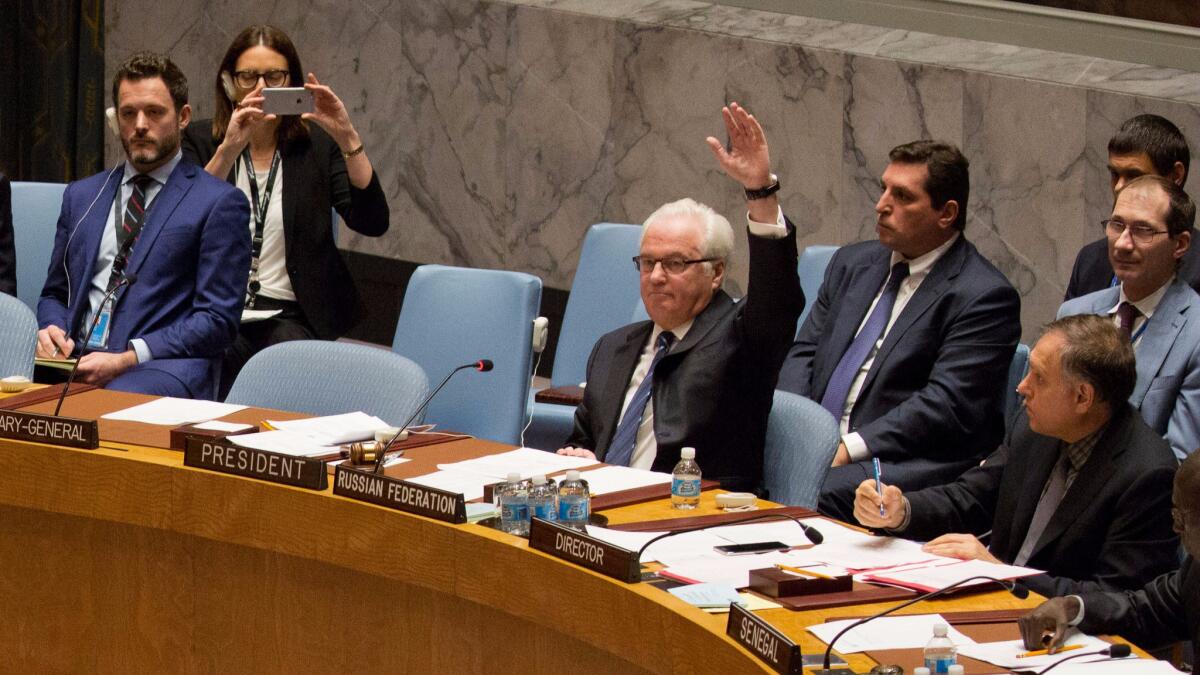 Russia's ambassador to the United Nations, Vitaly Churkin, vetoes a Security Council resolution on Syria at the U.N. headquarters in New York on Oct. 8.