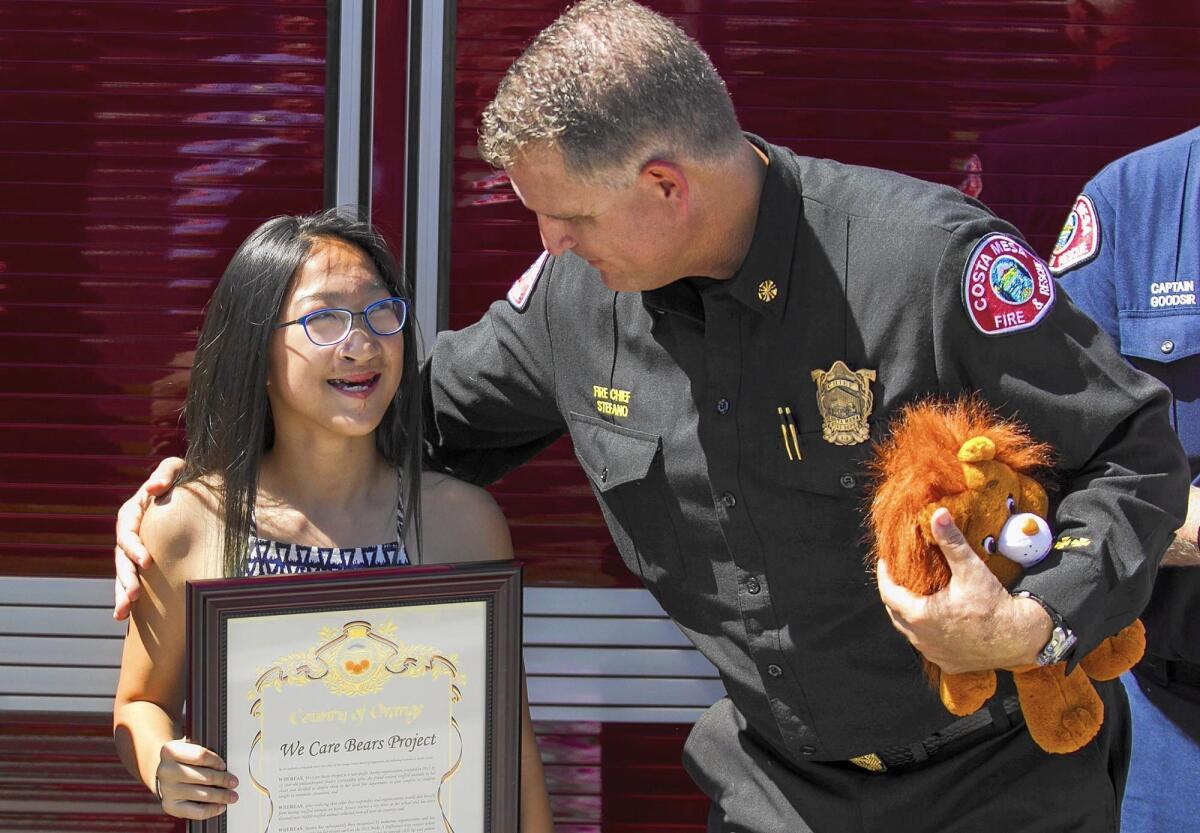 Costa Mesa Fire Chief Dan Stefano thanks Jessica Carscadden,13, on Friday for her donation of 500 Care Bears to O.C. firefighters on National Care Bears Share Your Care Day.