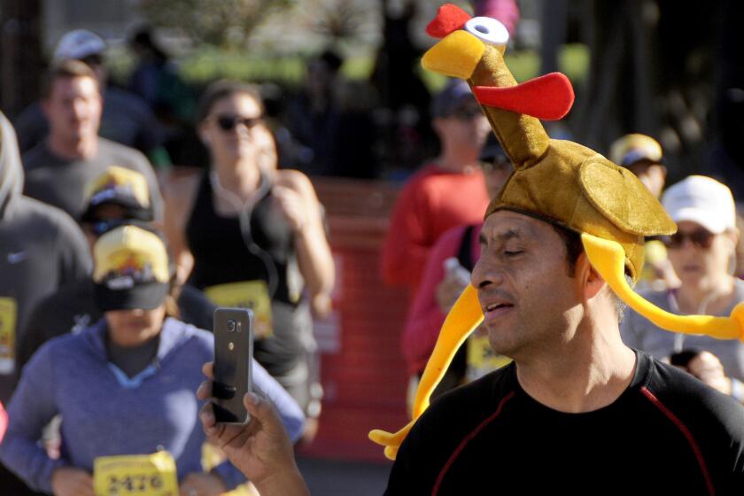 A runner with turkey on his mind races in the Midnight Mission's fourth annual Turkey Trot in downtown Los Angeles.