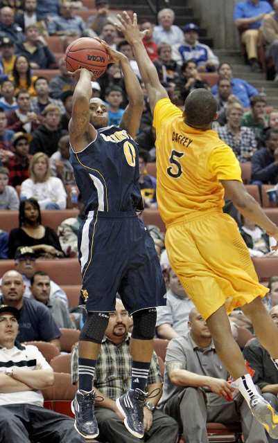 UC Irvine's Derick Flowers, left, pulls up as he attempts a three-pointer against Long Beach State's Mike Caffey.